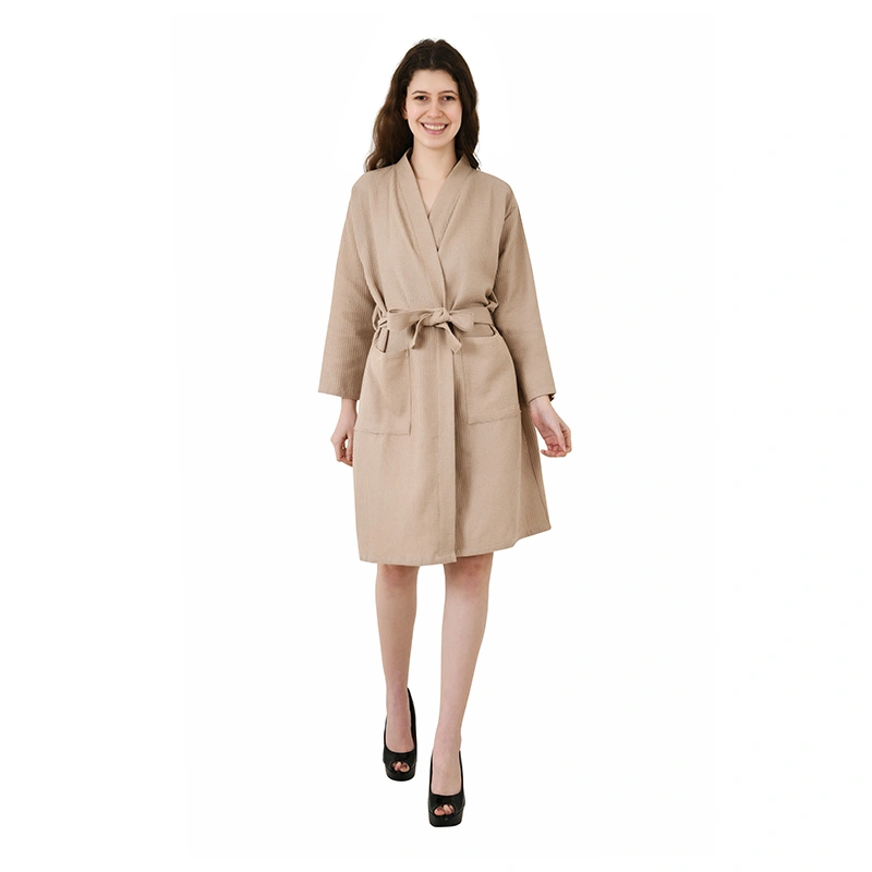 Sand beige waffle-textured knee-length bathrobe with tie belt, worn with heels - loungewear ecommerce photography by Lohar Studio Delhi